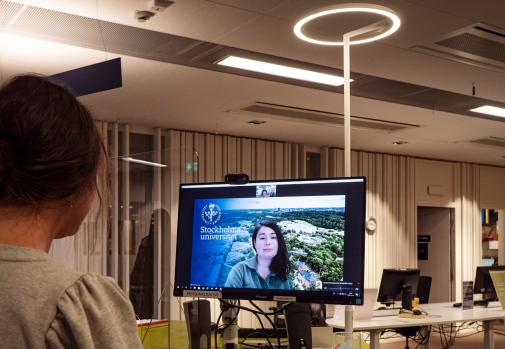 A visitor talks to a librarian via a screen by the information desk. Photo Cecilia Burman