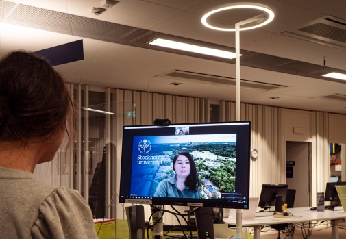 A visitor talks to a librarian via a screen by the information desk. Photo Cecilia Burman